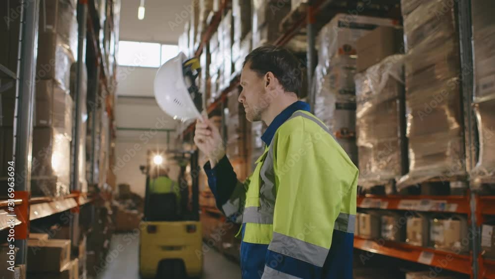 Warehouse worker with forklift in the warehouse of a freight forwarder Warehouse worker with forklift in the warehouse of a freight forwarder