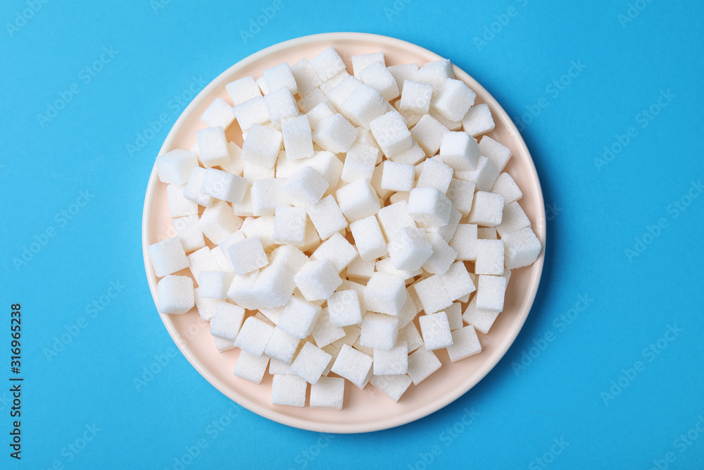 Refined sugar cubes on light blue background, top view Refined sugar cubes on light blue background, top view