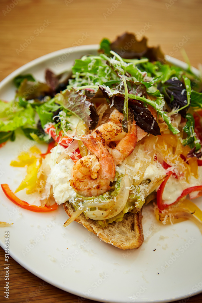 Grilled shrimp salad with tartar sauce and baguette Grilled shrimp salad with tartar sauce and baguette