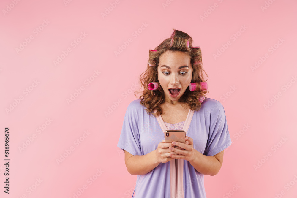 Image of young nice woman expressing surprise and using cellphone Image of young nice woman expressing surprise and using cellphone