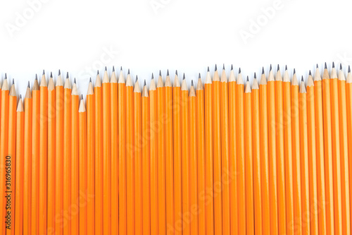 Close up view of a bunch of yellow pencils isolated on a white background. - Image