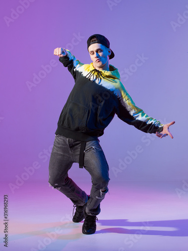 Breakdancing young man in hoodie and baseball cap. Dance school poster. Copy space. Battle competition announcement.