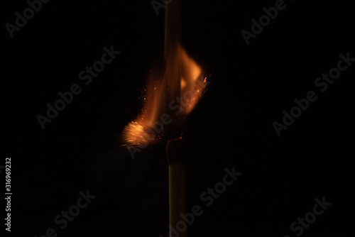Ignition of match with sparks isolated on black background space for text fire concept passion figures variety