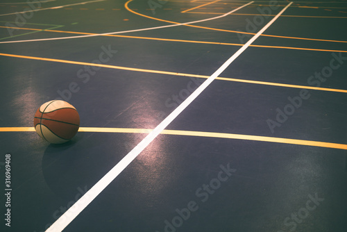 Very colorful basketball court with basketball, with white line standing out from the others.Sports concept © JAVIER LARRAONDO