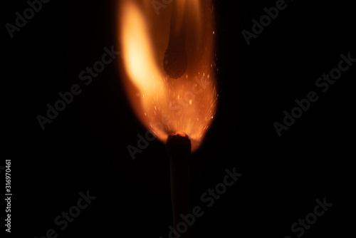 Ignition of match with sparks isolated on black background space for text fire concept passion figures variety © Valentin