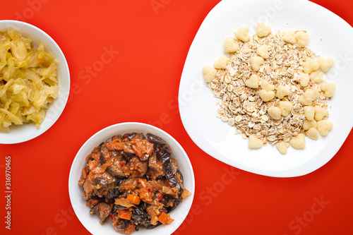 Healthy breakfast on a white plate on a colored background. Muesli with vegetable salad top view photo