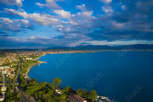 Cumulus clouds in the blue sky over Lake Garda Italy