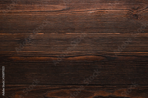 Dark wooden texture background. Warm atmosphere. Creative space and copyspace. Beautiful basis for flat lay.