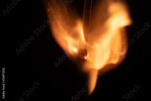 Ignition of match with sparks isolated on black background space for text fire concept passion figures variety