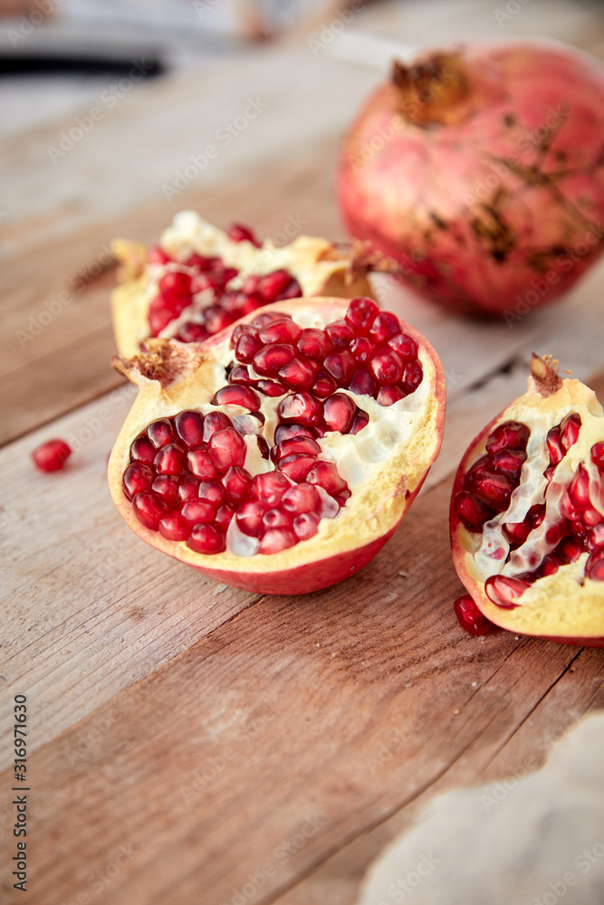 ripe organic pomegranate on teh wooden background ripe organic pomegranate on teh wooden background