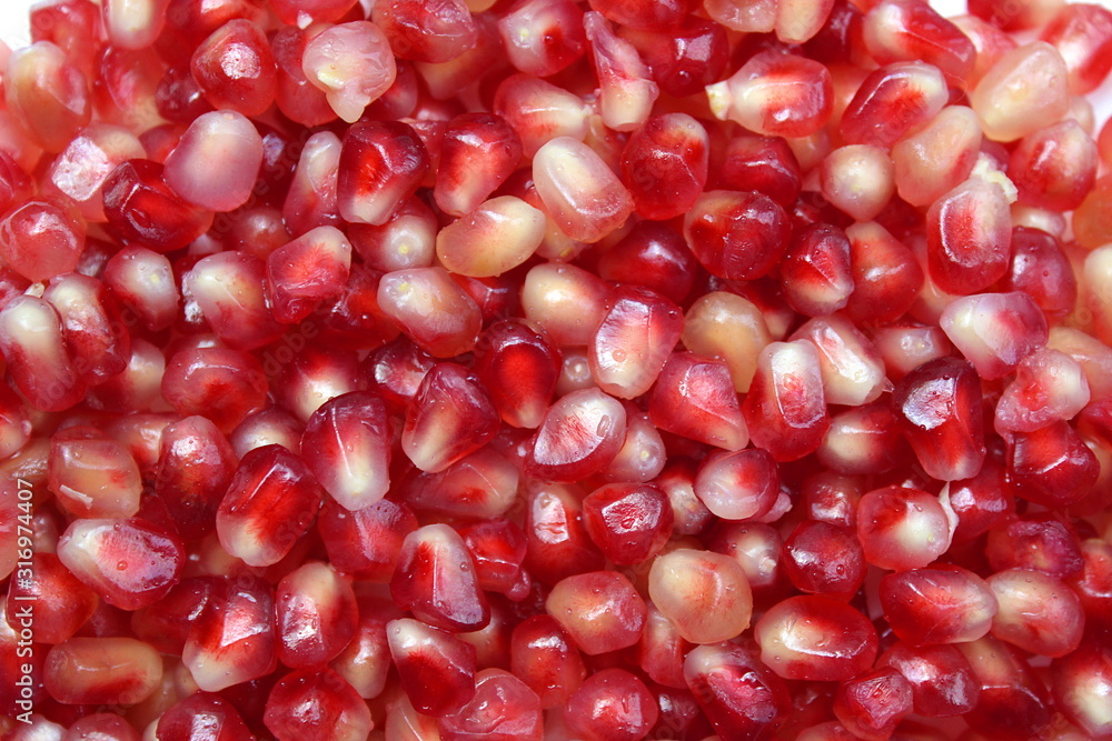 Texture of red pomegranate seeds laid out on the surface Texture of red pomegranate seeds laid out on the surface