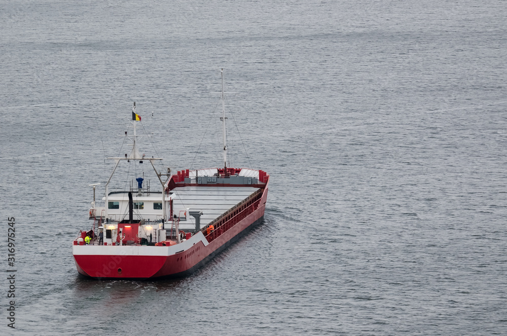 MERCHANT VESSEL - The ship sails with freight to port MERCHANT VESSEL - The ship sails with freight to port