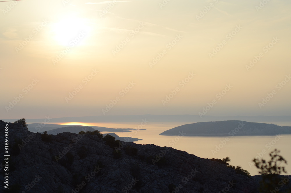 Sunset over the mountains in the sea