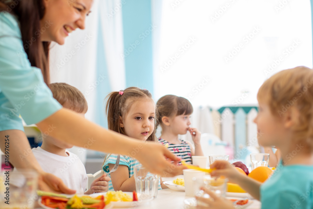 Group of kindergarten kids have lunch in day care Group of kindergarten kids have lunch in day care