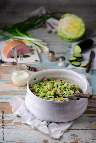 cabbage ham salad in ceramic bowl. selective focus