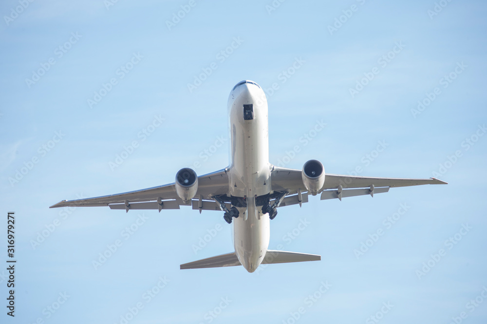 Passenger plane flying seen from below. Passenger plane flying seen from below.