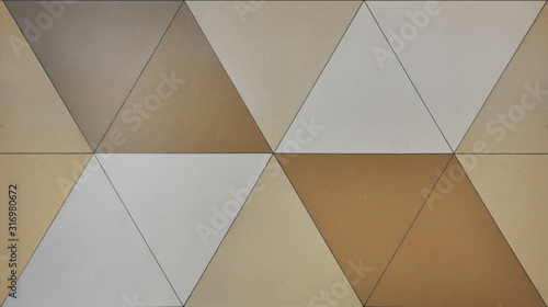 Seamless texture of multicolored polished triangular tiles. Floor and wall tile beige shades