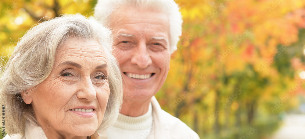 Close up portrait of smiling senior couple in autumn park Close up portrait of smiling senior couple in autumn park