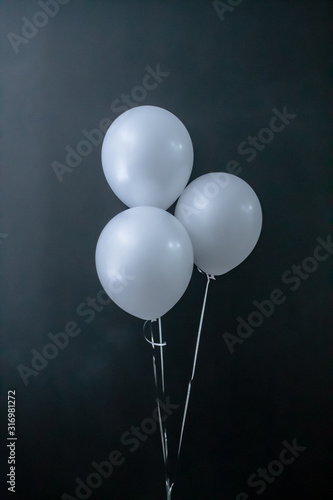 white air round balls on a black background. Valentine's Day, holiday, love. Place for text