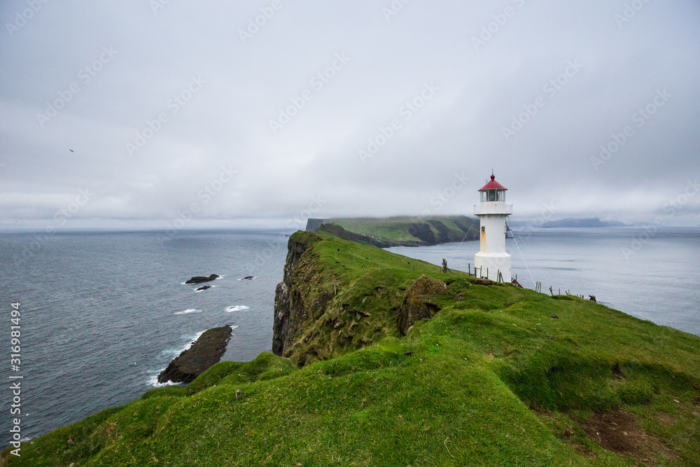 Mykines lighthouse, Faroe Islands. Foggy view of old lighthouse