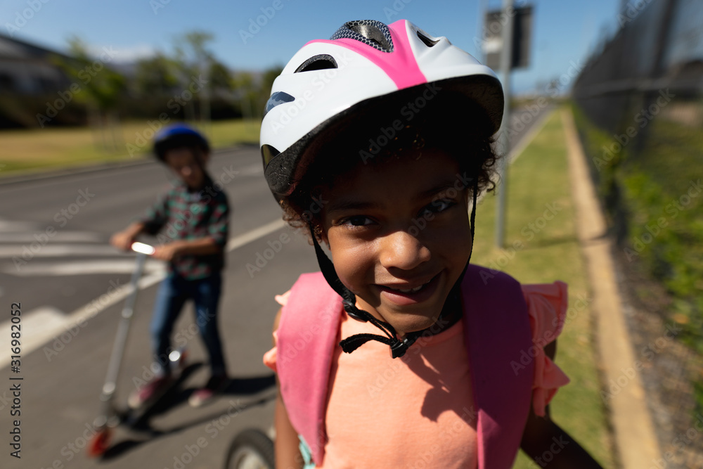 Schoolgirl wearing a cycling helmet and smiling to camera Schoolgirl wearing a cycling helmet and smiling to camera