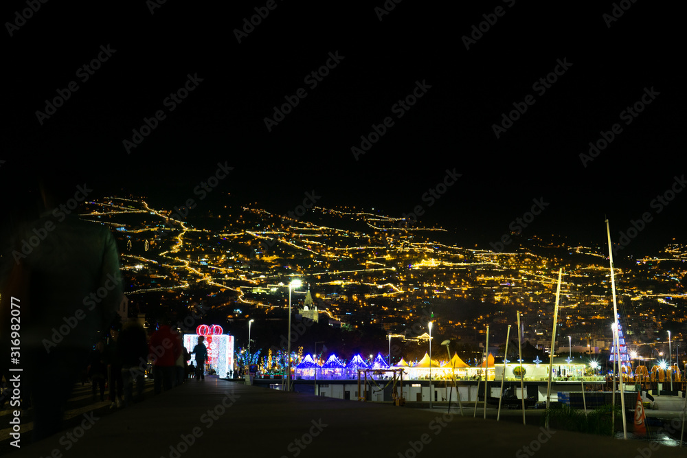 Funchal in Madeira, Portugal, with many lights at night, view from the sea