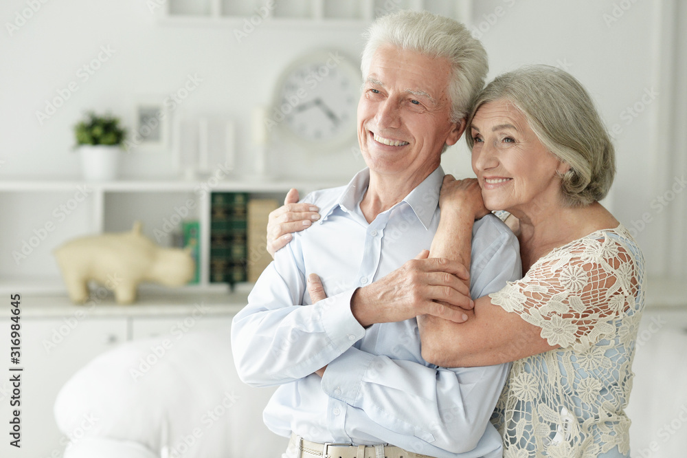 Portrait of cheerful senior couple embracing at home Portrait of cheerful senior couple embracing at home