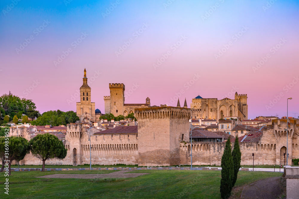Palace of the Popes, once fortress and palace, one of the largest and most important medieval Gothic buildings in Europe, at sunset, Avignon, France