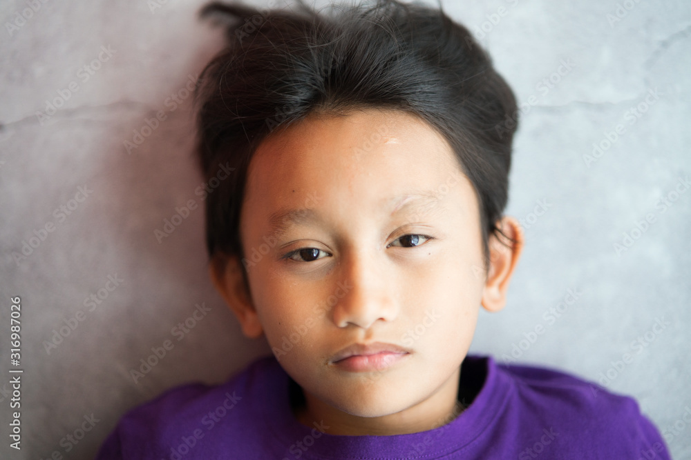 Little boy portrait close up face on concrete background