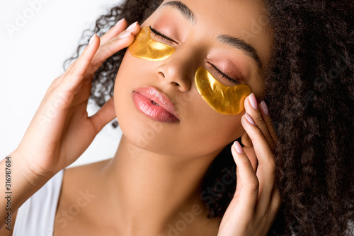 Fotografiet attractive african american girl with golden eye patches and closed eyes, isolat