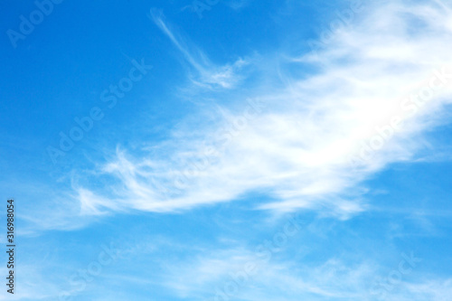 Background sky on a bright sunny day. Beautiful cumulus and cirrus thin clouds on a blue sky background. Blank for nature design