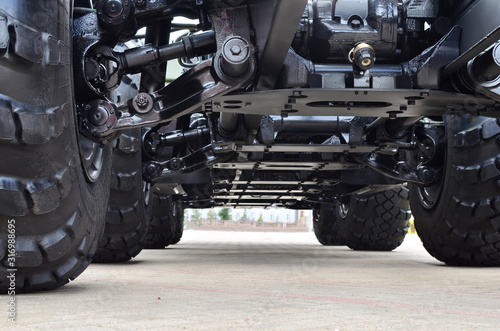 Lightweight fixed frame air suspension, air springs and shock absorbers on wheels with tyres. Truck suspension and steering linkage. Industrial workshop for the production of trucks and wheel chassis photo