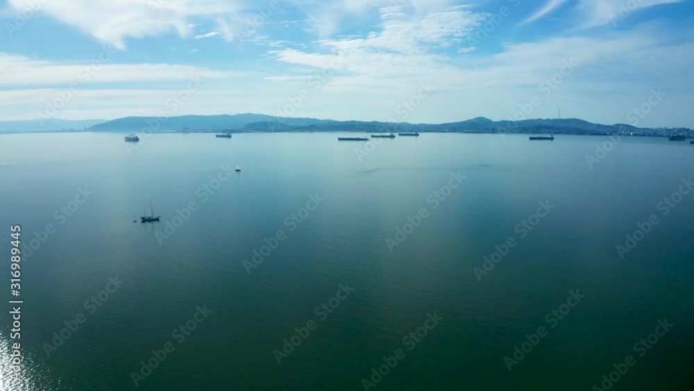 Ships pass over the glass smooth bay waters near the city. Ships pass over the glass smooth bay waters near the city.