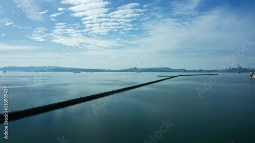 Nice clouds over the glassy waters of the bay and the golden city. photo