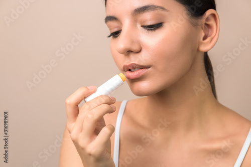 Принти на полотні lips care and protection. woman applying balm on lips