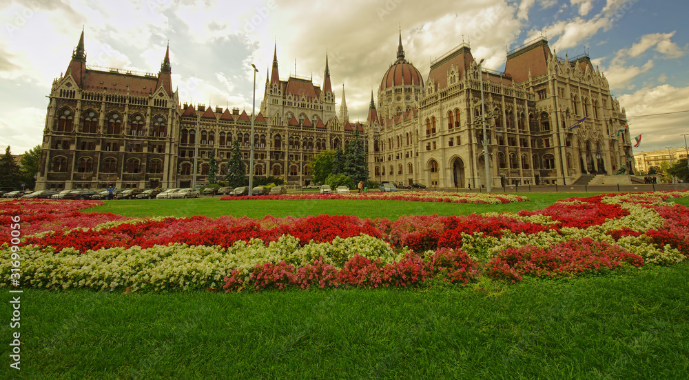garden of Budapest city Parliament full of flowers. wide view