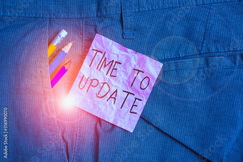 Text sign showing Time To Update. Business photo text The latest information about a particular situation Writing equipment and pink note paper inside pocket of man work trousers photo