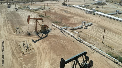 Oil Pumps jack. Oil industry equipment. Morning, blue sky. California state. USA country