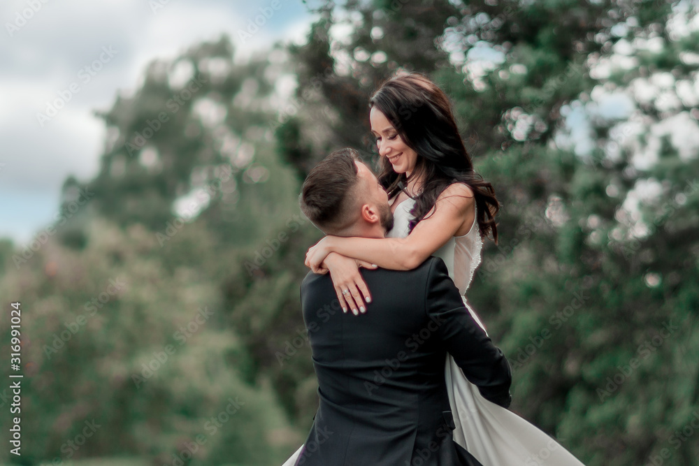 in full growth. bride and groom looking at each other tenderly in full growth. bride and groom looking at each other tenderly