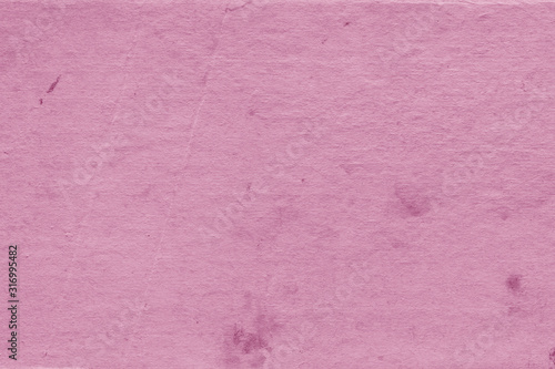 Cardboard pink abstract pattern texture close-up. Retro old paper background. Grunge concrete wall. Vintage blank wallpaper.