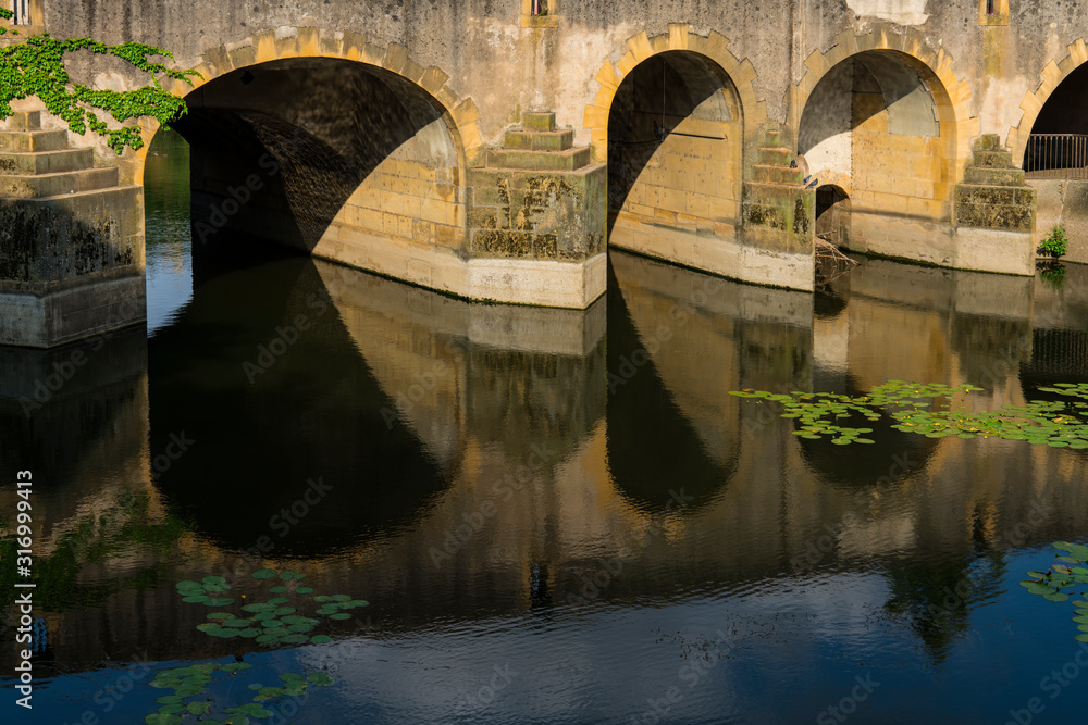 bridge with bows and reflection in river Moselle. Metz, France