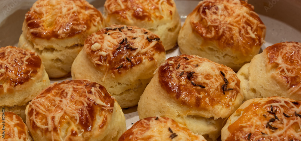 Close up of home baked traditional hungarian pastries pogacsa with cheese and cumin on top Close up of home baked traditional hungarian pastries pogacsa with cheese and cumin on top