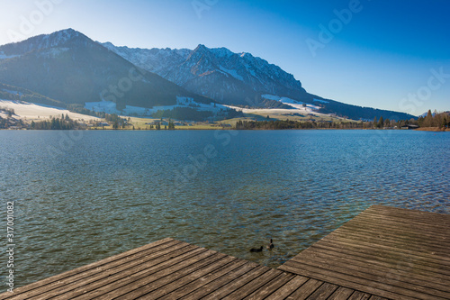 Steg und Berge am See - Walchsee in Österreich photo