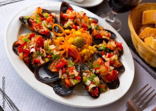 Delicious mussels served with vinaigrette from vegetables