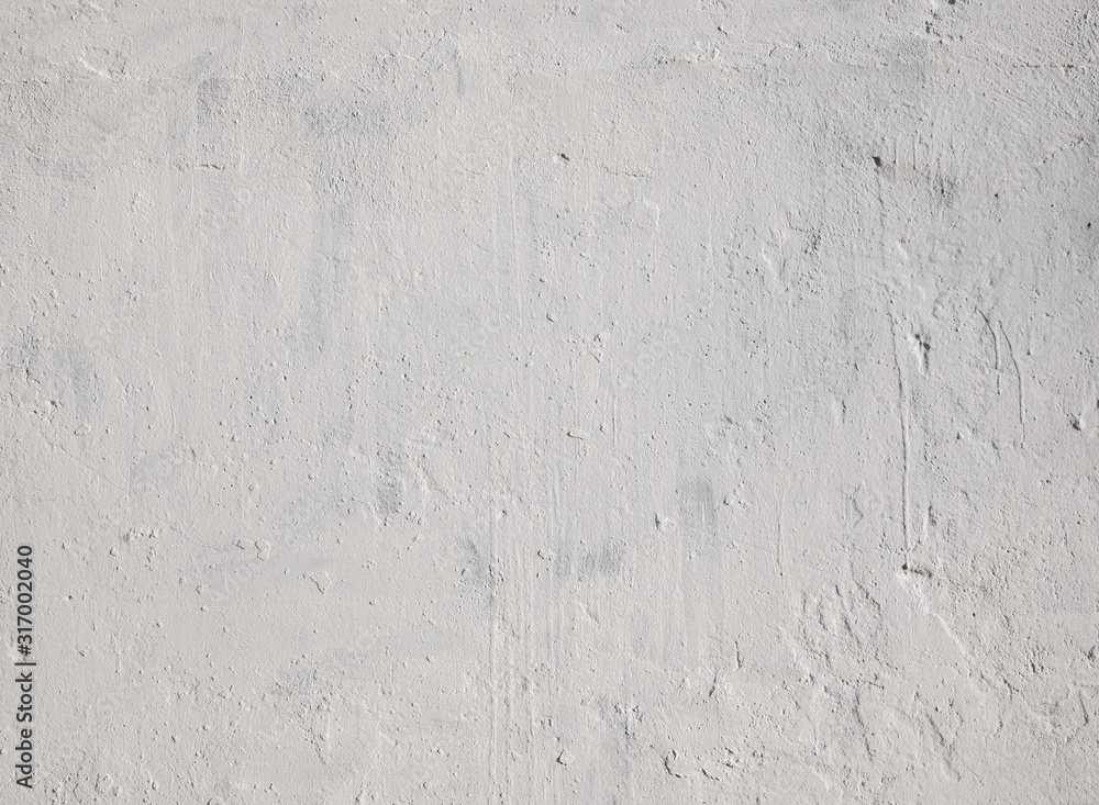 Fototapeta premium Texture of light gray stucco on the wall. Concrete wall covered with gray stucco.