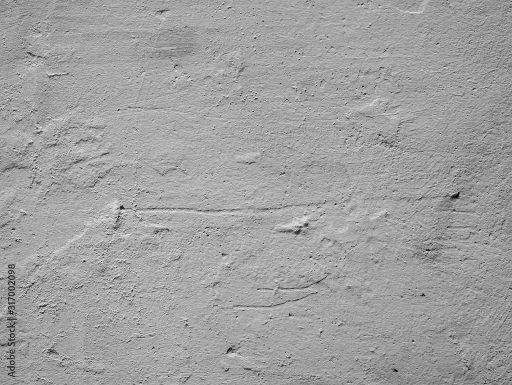 Obraz premium Old gray unevenly painted concrete wall. Texture of gray damaged plaster on the wall.