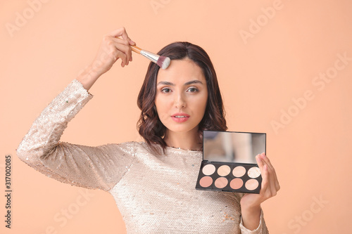 Young Woman Applying Face M...
