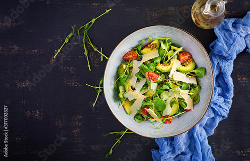 Fresh salad tomato, avocado, corn salad, chia seed and parmesan. Healthy food concept. Vegetarian cuisine. Dietary food. Top view, overhead