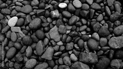 black pebbles on the beach background