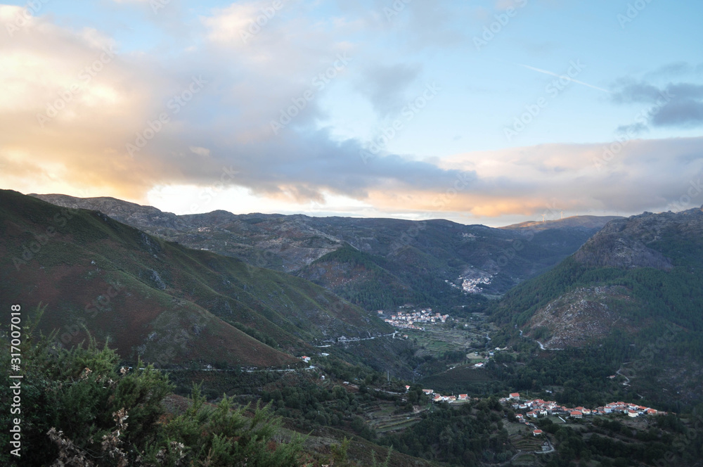 Golden hour in the mountains. The top of the mountain is illuminated by the sun. Geres. Portugal. Nature.